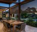 Channel-guided outdoor blinds fitted to a covered patio