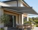 Retractable fold-arm awning shading an outdoor patio