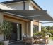 Retractable fold-arm awning shading an outdoor patio