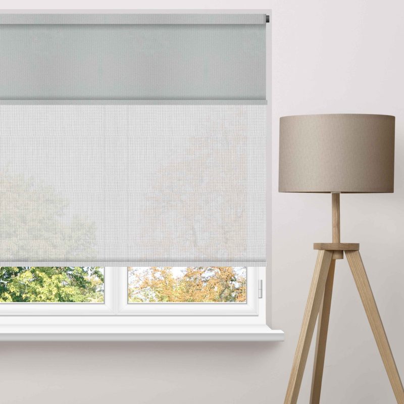 Motorised roller blinds fitted across large high windows in a contemporary living room