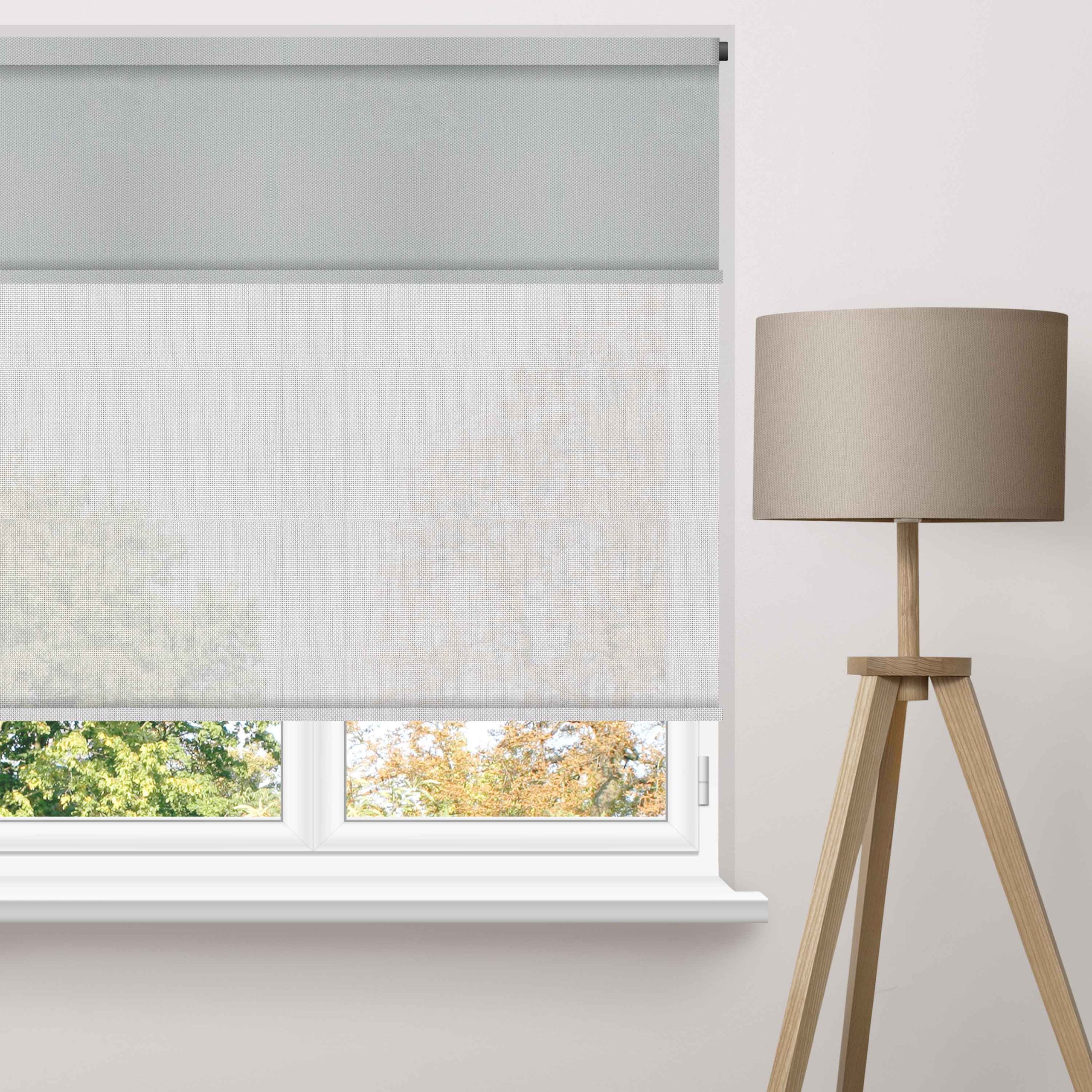 Motorised roller blinds fitted across large high windows in a contemporary living room