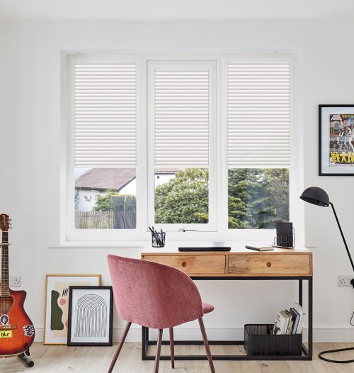 Blockout roller blind and layered curtain treatment in a calm South African bedroom