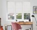 Blockout roller blind and layered curtain treatment in a calm South African bedroom