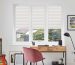 Blockout roller blind and layered curtain treatment in a calm South African bedroom