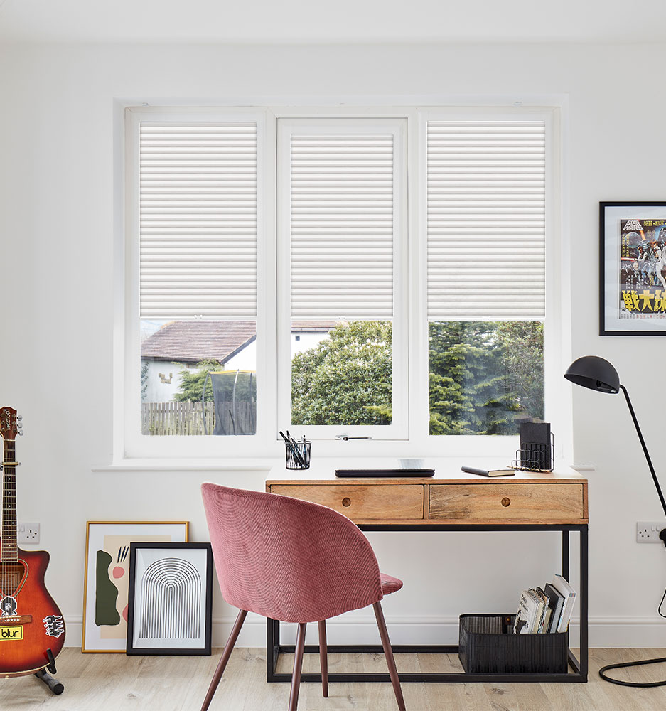 Blockout roller blind and layered curtain treatment in a calm South African bedroom