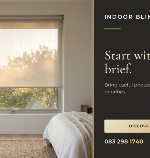 A translucent roller blind partly lowered across a bedroom window, with its frame and recess beside a bed.