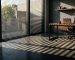 Horizontal window blinds beside a home-office desk and chair