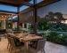 Retractable outdoor screens beside a covered patio dining area